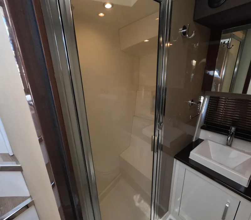 Slide: The Image of Modern bathroom interior in 2019 Carver C37 Coupe yacht, featuring a sleek shower and sink. - 18