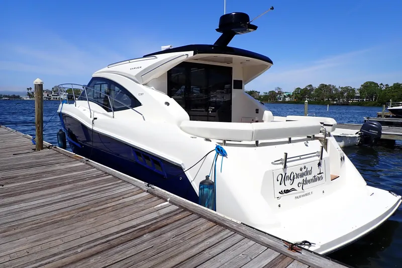 Slide: The Image of 2019 Carver C37 Coupe yacht docked by the water on a sunny day. - 2