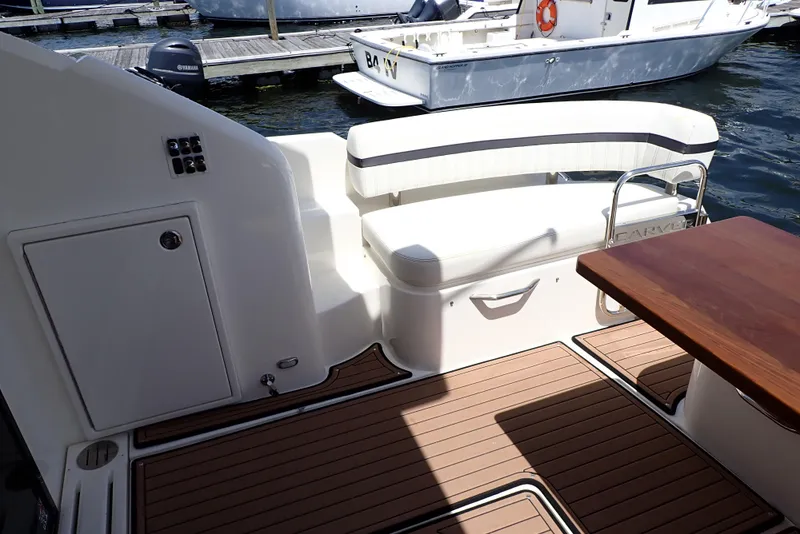 Slide: The Image of 2019 Carver C37 Coupe boat interior with seating and wooden deck. - 23
