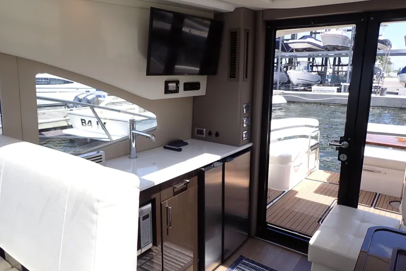 Slide: The Image of Interior of 2019 Carver C37 Coupe yacht with kitchenette and water view. - 27