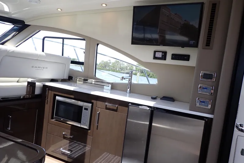 Slide: The Image of Interior of 2019 Carver C37 Coupe yacht with modern kitchen and entertainment system. - 30
