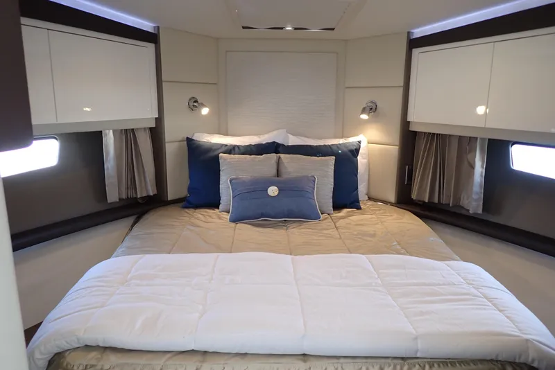 Slide: The Image of Luxurious bedroom interior of 2019 Carver C37 Coupe yacht with elegant bedding and lighting. - 31