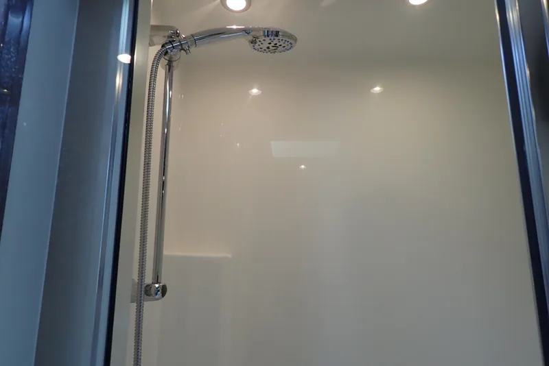 Slide: The Image of Shower area in 2019 Carver C37 Coupe yacht, featuring modern chrome fixtures. - 36