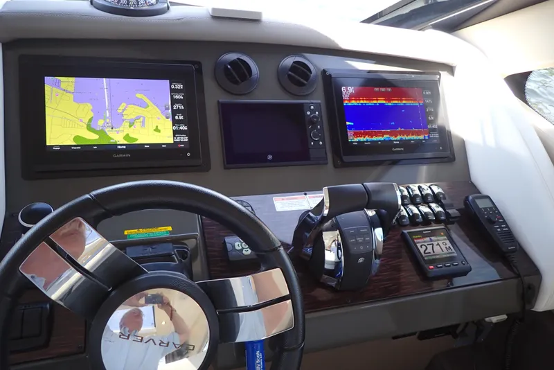 Slide: The Image of Dashboard of 2019 Carver C37 Coupe with navigation and control systems. - 38