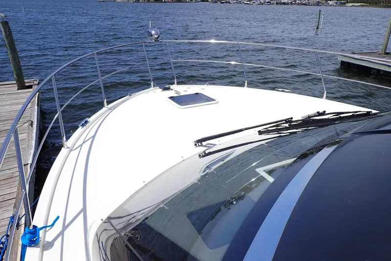 Slide: The Image of 2019 Carver C37 Coupe yacht docked by the water, showcasing sleek design and spacious deck. - 39