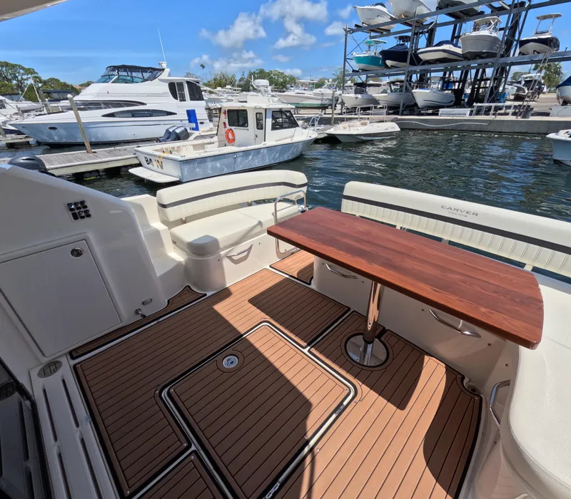 Slide: The Image of 2019 Carver C37 Coupe yacht with teak deck and wooden table at marina. - 5