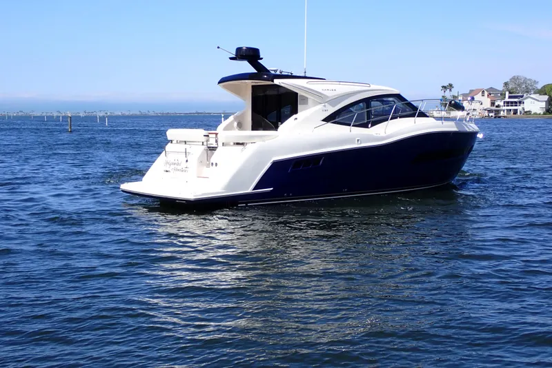 Slide: The Image of 2019 Carver C37 Coupe yacht cruising on a sunny day in open water. - 70