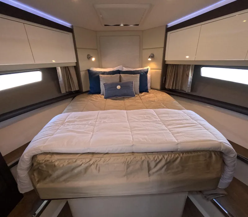 Slide: The Image of Luxurious bedroom interior of 2019 Carver C37 Coupe yacht with elegant bedding and ambient lighting. - 13