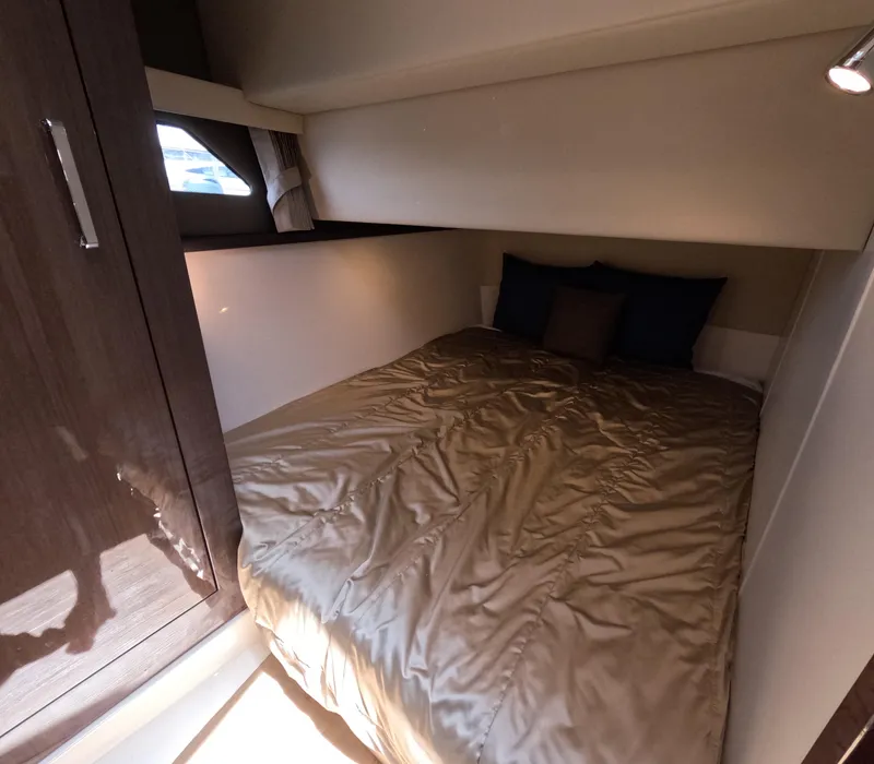 Slide: The Image of Cozy bedroom interior of 2019 Carver C37 Coupe yacht with plush bedding and modern design. - 15