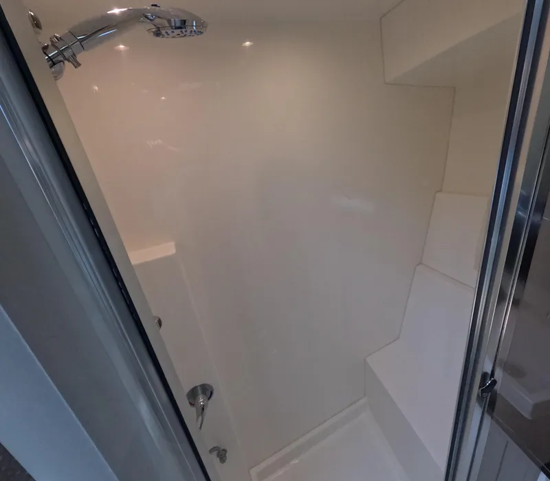 Slide: The Image of Shower area inside 2019 Carver C37 Coupe, featuring modern fixtures and sleek design. - 17