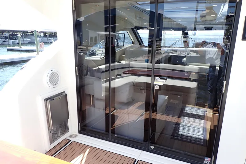 Slide: The Image of 2019 Carver C37 Coupe yacht interior with glass doors and luxurious seating. - 24