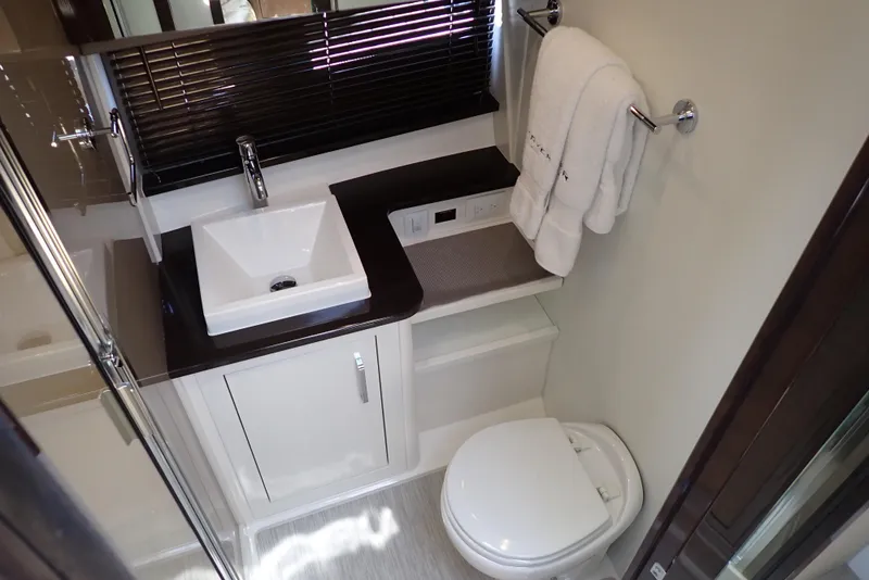 Slide: The Image of Luxurious bathroom in 2019 Carver C37 Coupe with modern sink and toilet. - 34