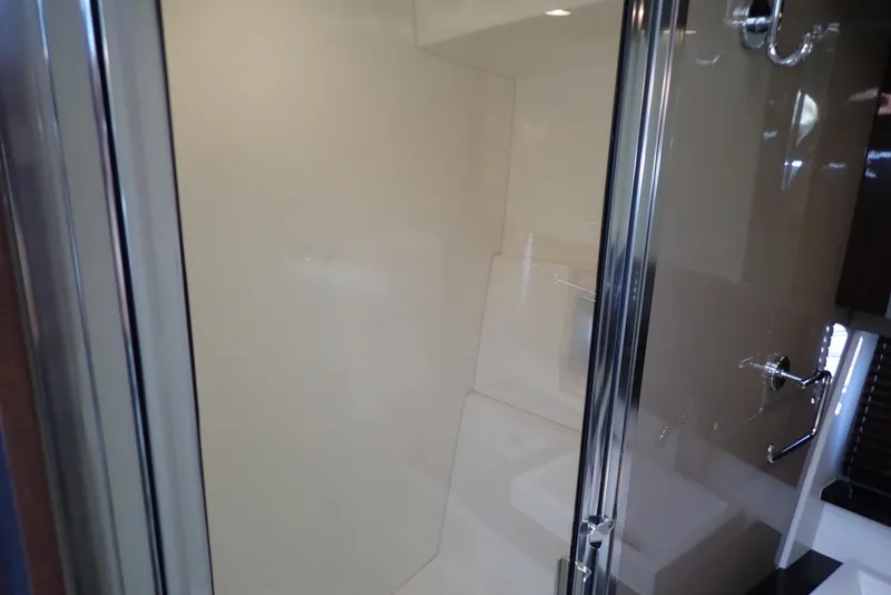 Slide: The Image of Shower area inside 2019 Carver C37 Coupe yacht, featuring sleek glass doors and modern fixtures. - 35