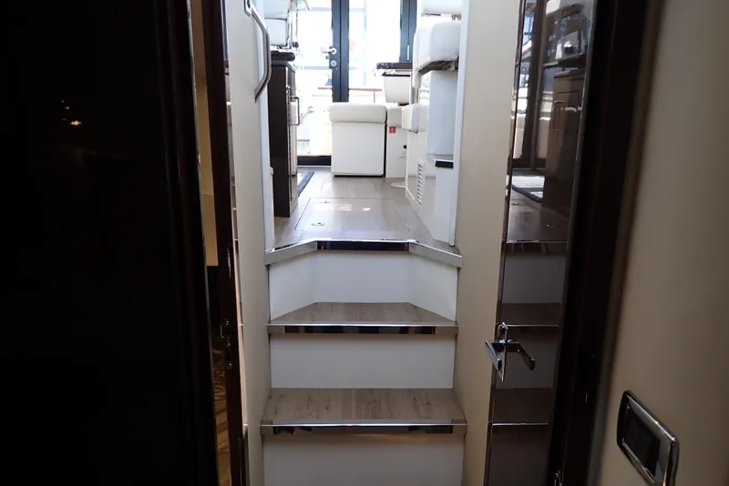 Slide: The Image of Interior view of 2019 Carver C37 Coupe yacht, featuring stairs leading to the main cabin. - 37