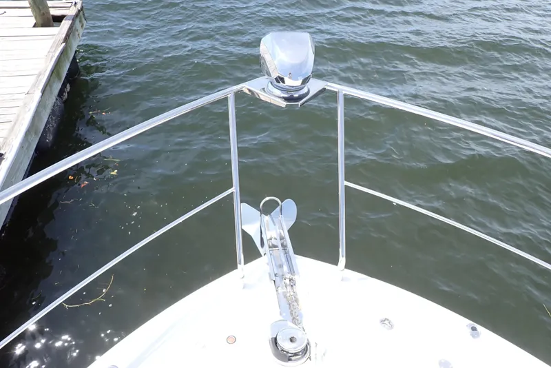 Slide: The Image of Bow of 2019 Carver C37 Coupe yacht with anchor, docked by water. - 42