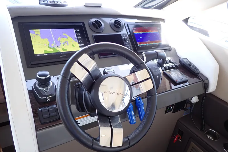 Slide: The Image of 2019 Carver C37 Coupe helm with navigation screens and controls. - 43