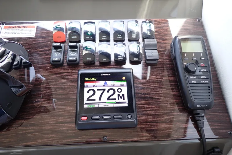 Slide: The Image of Control panel of a 2019 Carver C37 Coupe with Garmin navigation and communication devices. - 44