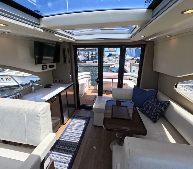 Slide: The Image of Interior of 2019 Carver C37 Coupe yacht with modern seating and kitchen area. - 7