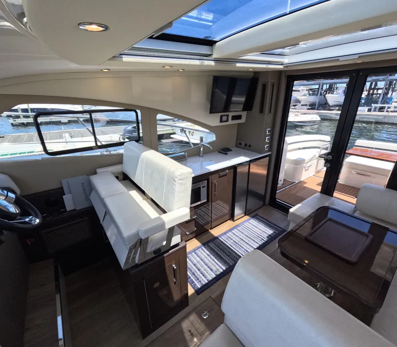 Slide: The Image of Luxurious interior of 2019 Carver C37 Coupe yacht with modern kitchen and seating area. - 9