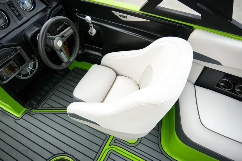 Slide: The Image of 2016 Axis A22 boat interior with white seating and green accents. - 14