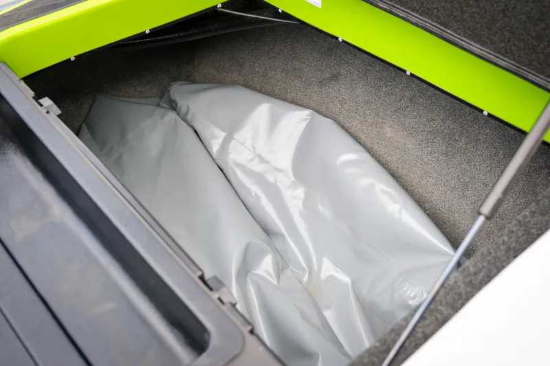 Slide: The Image of 2016 Axis A22 boat storage compartment with gray interior and green trim. - 20