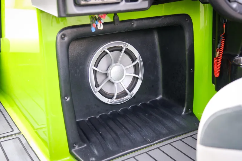 Slide: The Image of 2016 Axis A22 boat interior with speaker and vibrant green paneling. - 23