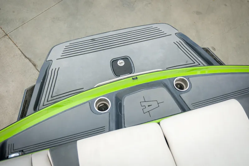Slide: The Image of 2016 Axis A22 boat deck with green accents and cup holders. - 25