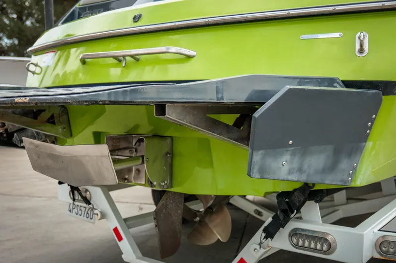 Slide: The Image of 2016 Axis A22 boat rear view with green hull and propeller details. - 5