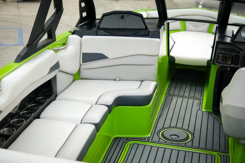 Slide: The Image of 2016 Axis A22 boat interior with green accents and white seating. - 7