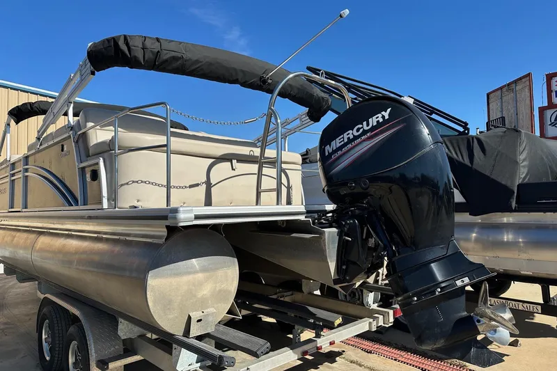 Slide: The Image of 2019 Harris Cruiser 230 pontoon boat with Mercury outboard motor on trailer. - 2