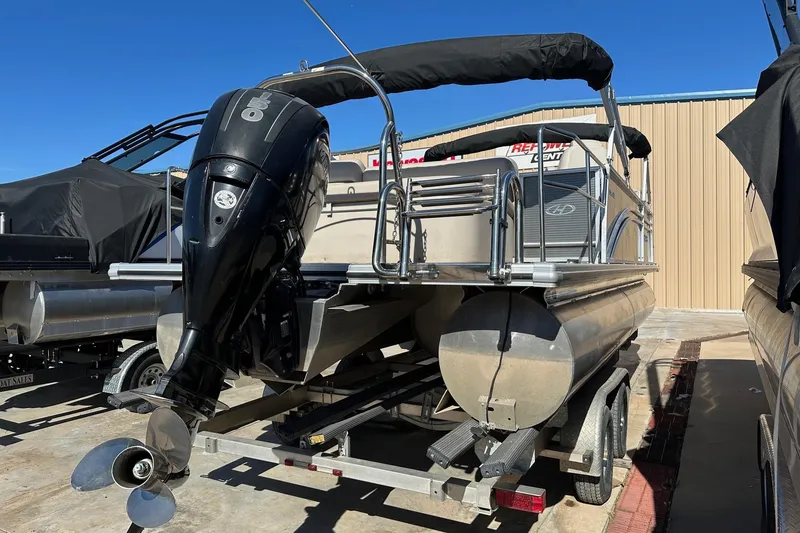 Slide: The Image of 2019 Harris Cruiser 230 pontoon boat with outboard motor on trailer. - 3