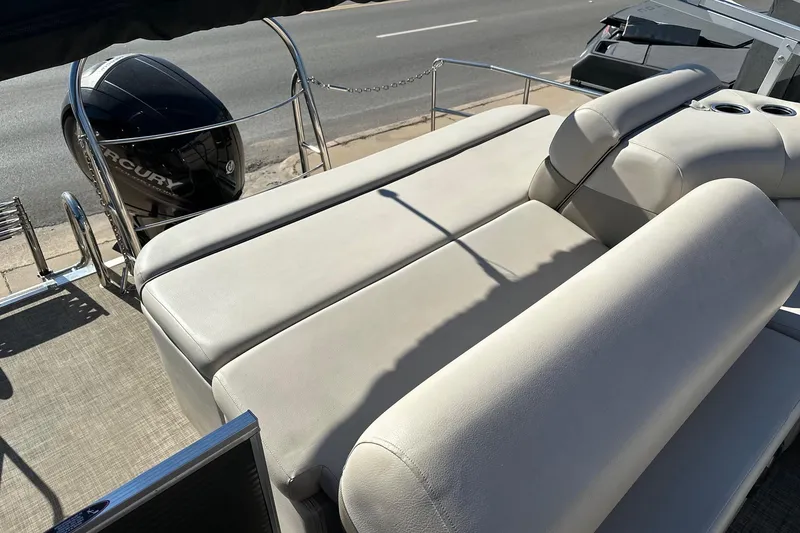 Slide: The Image of 2019 Harris Cruiser 230 boat with comfortable seating and Mercury outboard motor. - 9