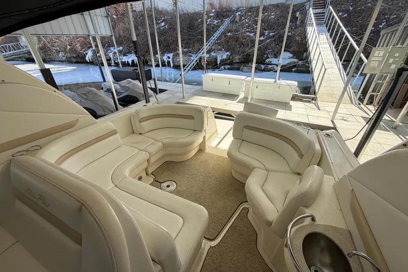 Slide: The Image of 2008 Sea Ray 38 Sundancer interior with plush seating and outdoor view. - 13
