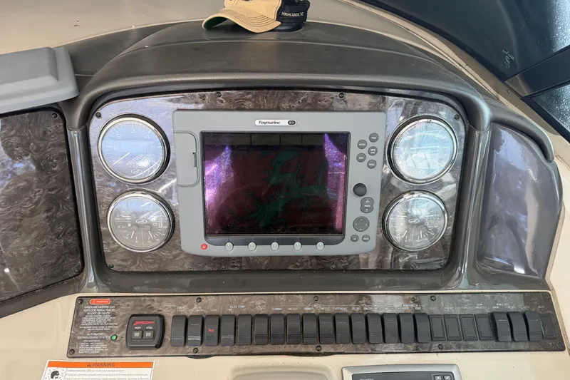 Slide: The Image of Control panel of a 2008 Sea Ray 38 Sundancer boat with gauges and Raymarine display. - 16