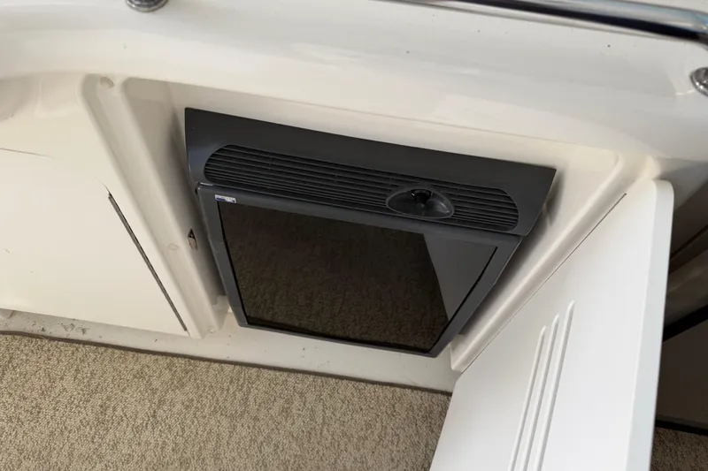 Slide: The Image of 2008 Sea Ray 38 Sundancer interior with built-in mini fridge and carpeted flooring. - 20