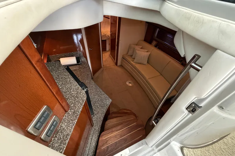Slide: The Image of Interior of 2008 Sea Ray 38 Sundancer yacht with cozy seating and modern kitchenette. - 21