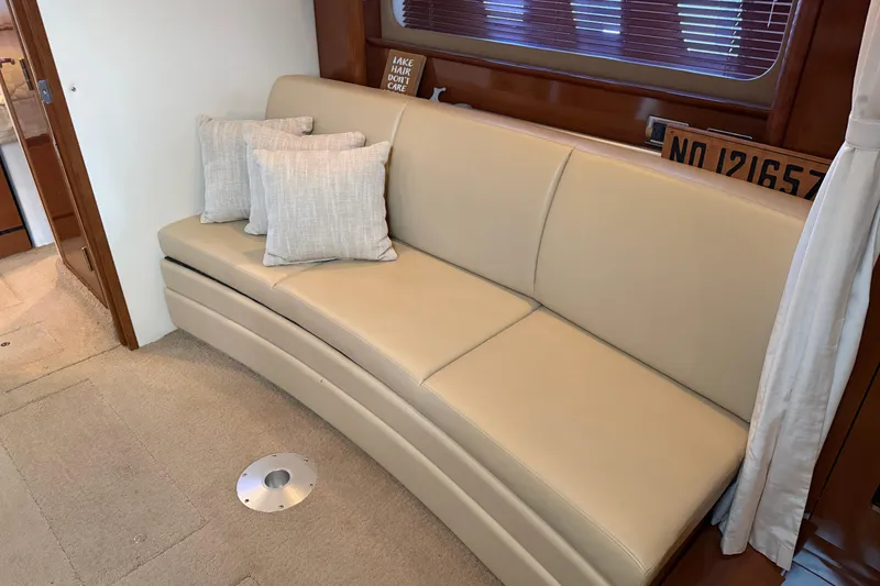Slide: The Image of Interior of 2008 Sea Ray 38 Sundancer with beige leather sofa and decorative pillows. - 24