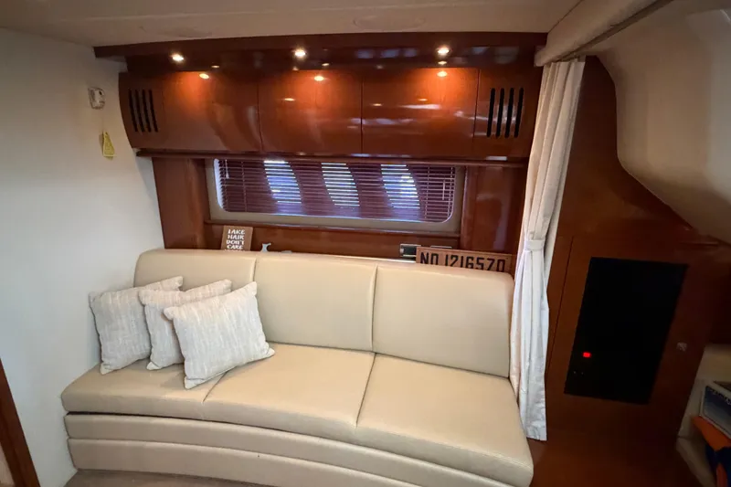 Slide: The Image of Interior of 2008 Sea Ray 38 Sundancer with beige sofa and wooden cabinetry. - 25