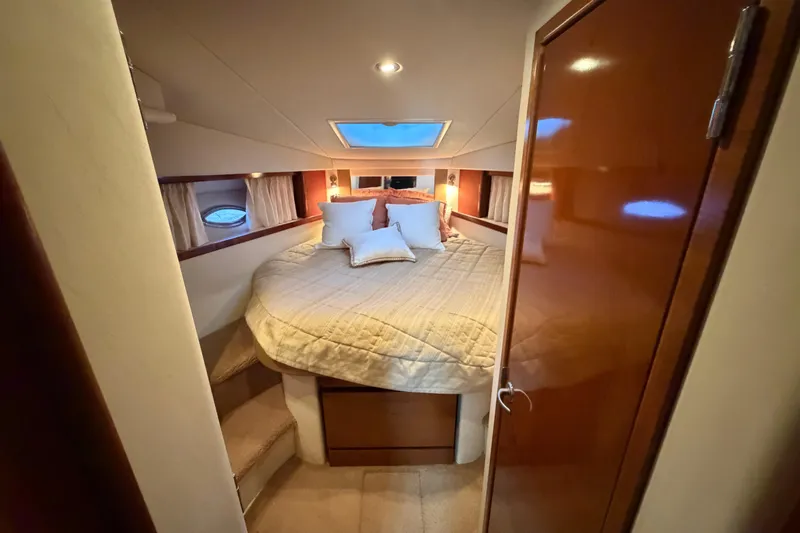 Slide: The Image of Luxurious cabin interior of 2008 Sea Ray 38 Sundancer yacht with cozy bed and ambient lighting. - 28