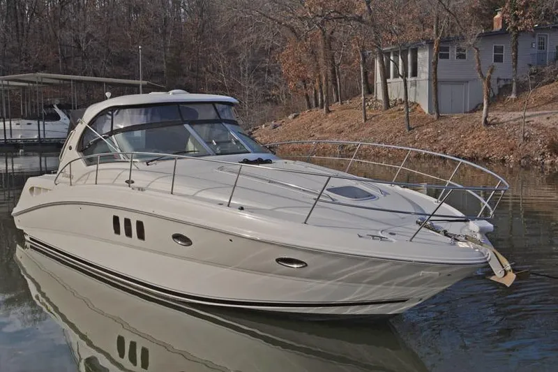 Slide: The Image of 2008 Sea Ray 38 Sundancer yacht docked on a calm lake with wooded shoreline. - 3