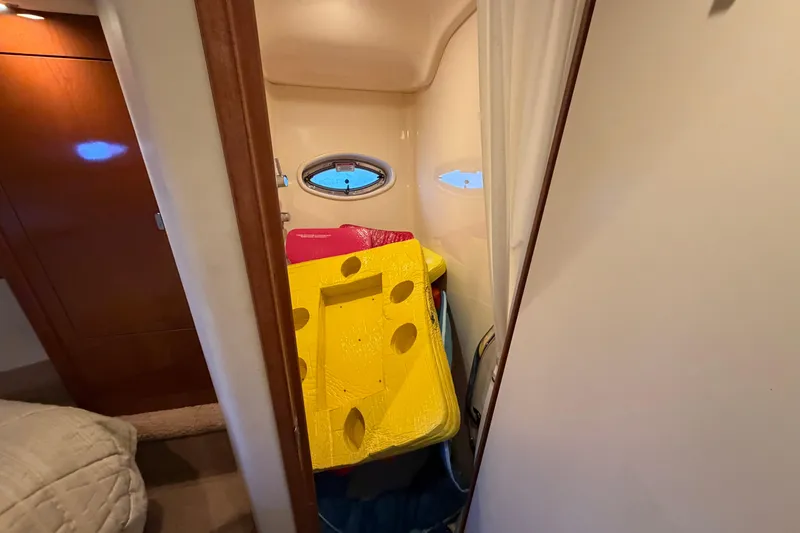 Slide: The Image of Interior of 2008 Sea Ray 38 Sundancer with colorful inflatables and porthole window. - 31