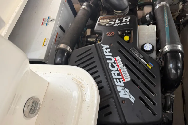 Slide: The Image of Engine compartment of 2008 Sea Ray 38 Sundancer with Mercury engine components visible. - 37