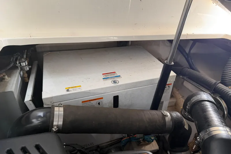 Slide: The Image of Engine compartment of a 2008 Sea Ray 38 Sundancer boat, showing mechanical components. - 39