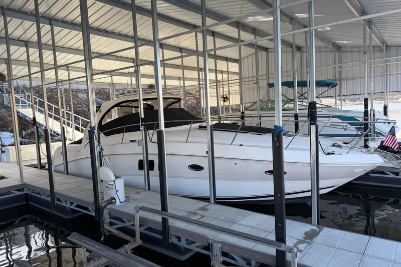 Slide: The Image of 2008 Sea Ray 38 Sundancer docked in a covered marina slip. - 4