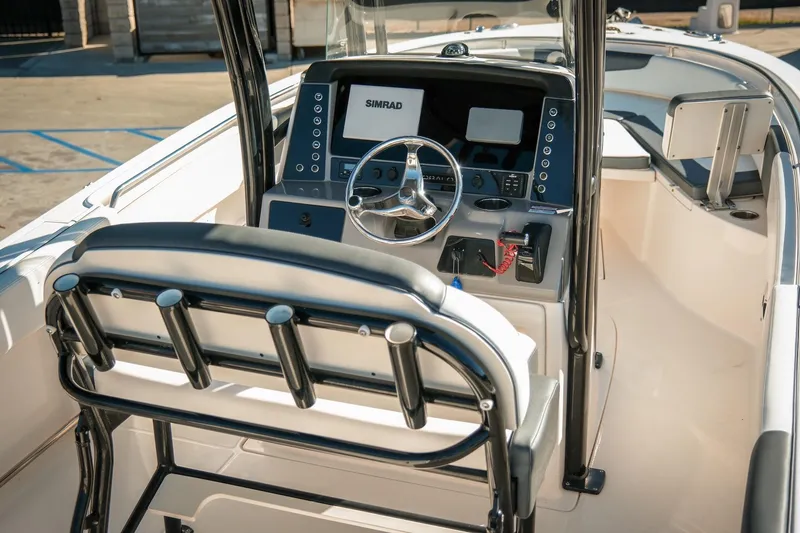 Slide: The Image of 2020 Robalo R242 Center Console boat interior with steering wheel and control panel. - 10