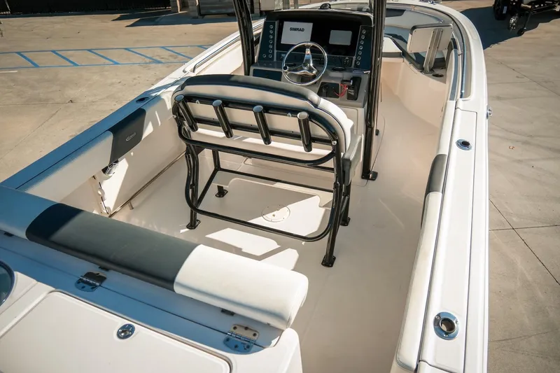 Slide: The Image of 2020 Robalo R242 Center Console boat interior with steering console and seating. - 11
