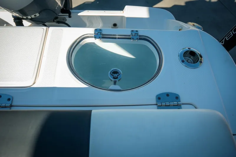 Slide: The Image of 2020 Robalo R242 Center Console boat with livewell and seating area. - 13