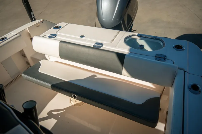 Slide: The Image of 2020 Robalo R242 Center Console boat interior with seating and storage features. - 15