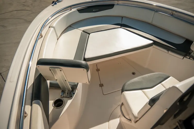 Slide: The Image of 2020 Robalo R242 Center Console boat interior with cushioned seating and stainless steel details. - 19