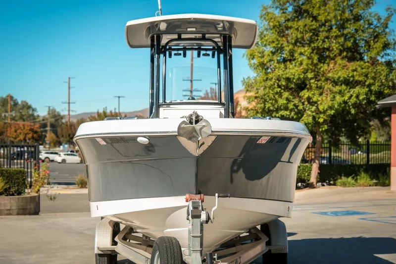 Slide: The Image of 2020 Robalo R242 Center Console boat on trailer, parked outdoors. - 3